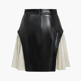 Nerine | Kontrastreicher Kunstleder-Skaterrock mit ausgestellten Stoffeinsätzen und High-Waist-Schnitt