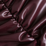 Jocasta | Figurbetonter Kunstleder-Minirock mit seitlicher Raffung und asymmetrischem Saum